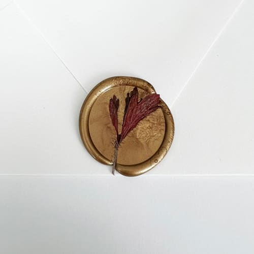 This is a red wax seals by Caitlin Home called red anemone leaves wax seal in gold | pack of 10 in standard