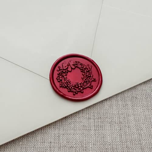 This is a red wax seals by Orchid Studio called metallic red christmas wreath wax seal sticker | set of 10 in standard