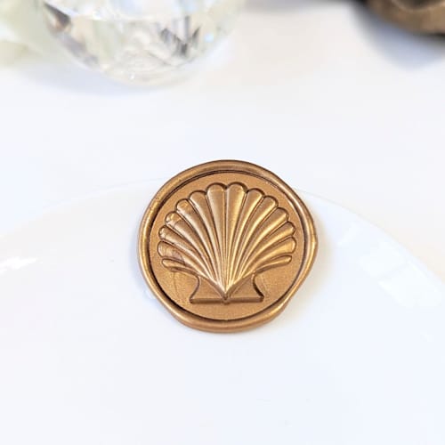 This is a multicolor wax seals by Inkspiringletters called modern seashell- customizable color- set of 25 hand-crafted wax seals in standard