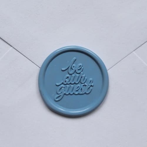 This is a gold wax seals by MC silverlinings called customizable be our guest self-adhesive wax seals, set of 5 in standard