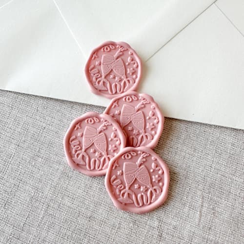 This is a pink wax seals by Orchid Studio called dusty rose celebration wax seal sticker - champagne toast | set of 10 in standard