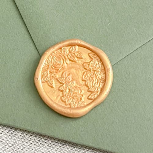 This is a gold wax seals by Orchid Studio called roses self-adhesive wax seals in yellow gold | set of 10 in standard