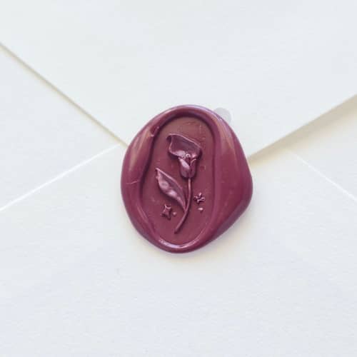 This is a purple wax seals by Inkspiringletters called calla lily- mulberry - hand-crafted wax seals- set of 25 in standard