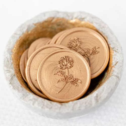 This is a gold wax seals by Lindsey Cain called pretty in peony (sold in sets of 10) in standard