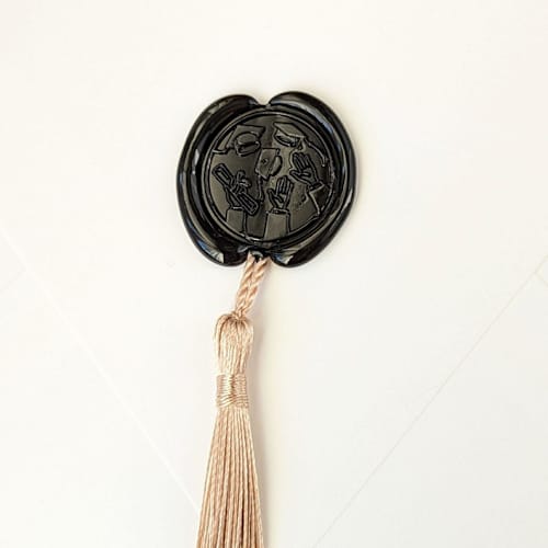 This is a multicolor wax seals by Inkspiringletters called hat toss- customizable wax color- set of 25 hand-crafted wax seals with gold tassels in standard