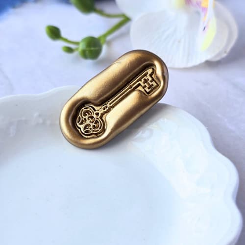 This is a multicolor wax seals by Inkspiringletters called skeleton key- customizable color- set of 25 hand-crafted wax seals in standard