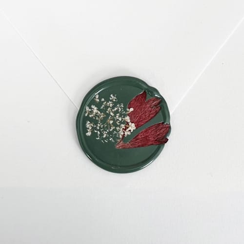 This is a green wax seals by Caitlin Home called queen anne's lace wax seal in green | pack of 10 in standard