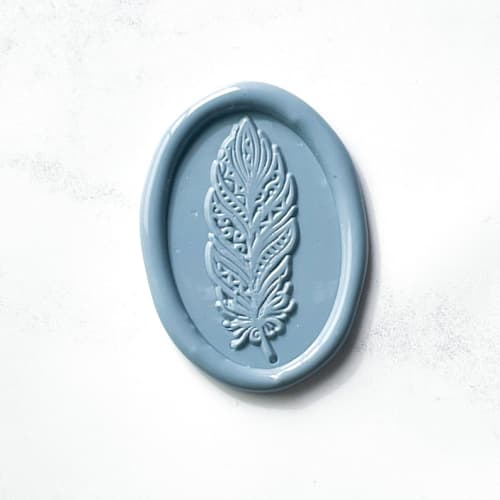 This is a blue wax seals by Abby Choi called feather wax seal in dusty blue pack of 10 in standard