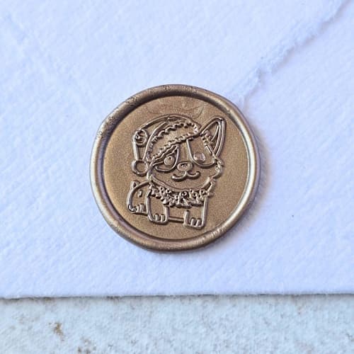 This is a multicolor wax seals by Inkspiringletters called santa paws- customizable color- set of 25 hand-crafted wax seals in standard