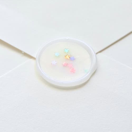 This is a multicolor wax seals by Inkspiringletters called star glitter- customizable - hand-crafted wax seals- set of 25 in standard