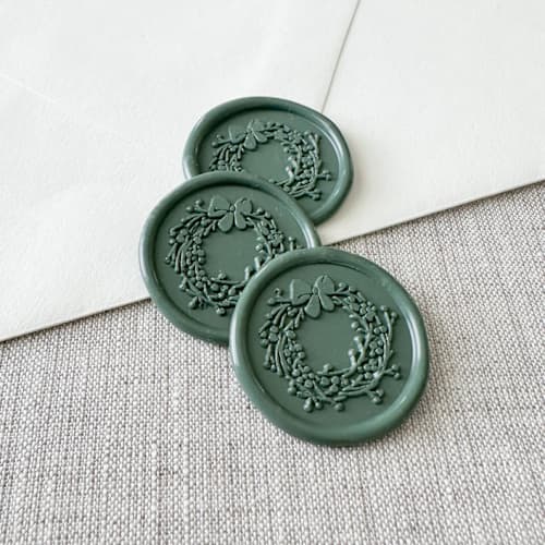 This is a green wax seals by Orchid Studio called olive green christmas wreath wax seal sticker | set of 10 in standard