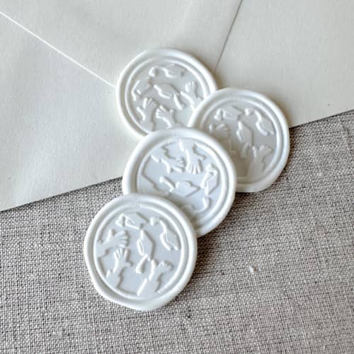This is a white wax seals by Orchid Studio called white graduation wax seal - graduation cap throw | set of 10 in standard