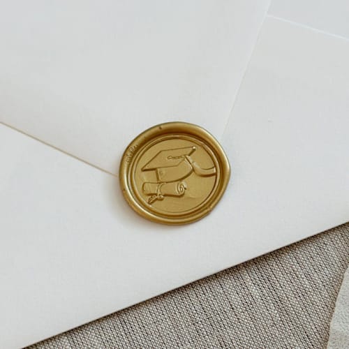 This is a gold wax seals by Orchid Studio called classic gold graduation wax seal stickers | set of 10 in standard