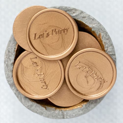 This is a gold wax seals by Lindsey Cain called let's party (sold in sets of 10) in standard