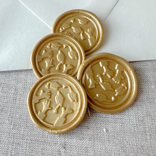 This is a gold wax seals by Orchid Studio called classic gold graduation wax seal - graduation cap throw | set of 10 in standard