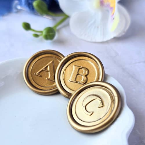 This is a multicolor wax seals by Inkspiringletters called serif monogram (a-z) - customizable color- set of 25 hand-crafted wax seals in standard