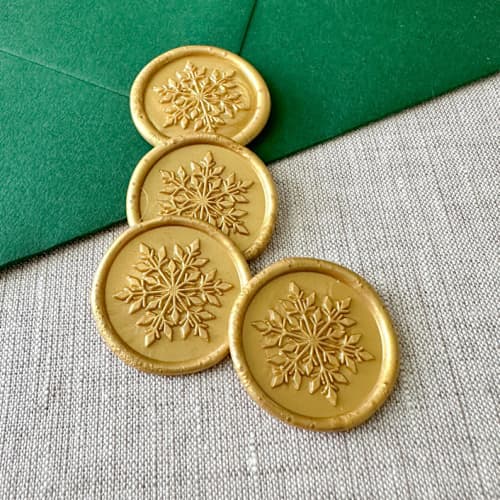 This is a gold wax seals by Orchid Studio called classic gold snowflake wax seal sticker | set of 10 in standard