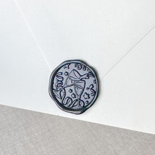 This is a black wax seals by Orchid Studio called black celebration wax seal sticker - champagne toast | set of 10 in standard