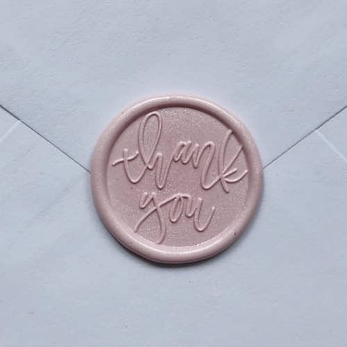 This is a pink wax seals by MC silverlinings called customizable color thank you cursive b wax seals, set of 5 in standard