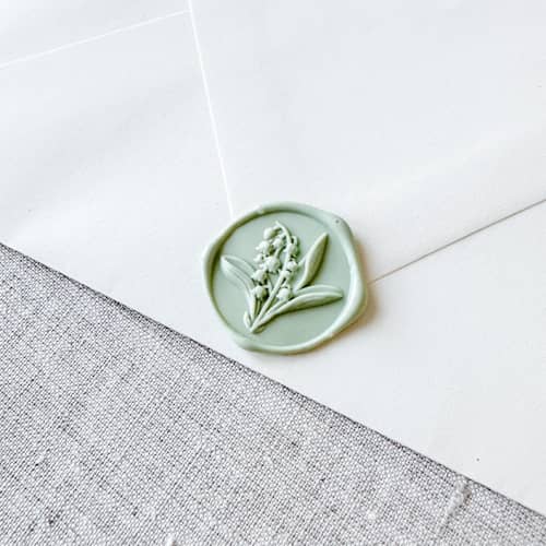 This is a green wax seals by Orchid Studio called sage green lily of the valley 3d wax seal stickers | set of 10 in standard