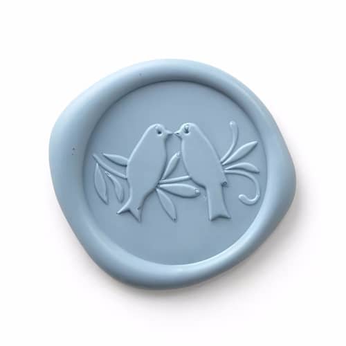 This is a blue wax seals by Papel Custom Design called love birds - dusty blue - set of 25 in standard