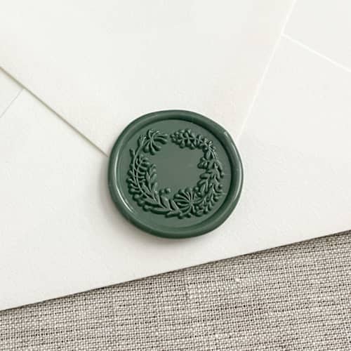 This is a green wax seals by Orchid Studio called wreath self-adhesive wax seal in olive green | set of 10 in standard