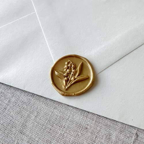 This is a gold wax seals by Orchid Studio called classic gold lily of the valley 3d wax seal stickers | set of 10 in standard