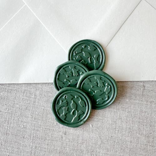 This is a green wax seals by Orchid Studio called olive green graduation wax seal - graduation cap throw | set of 10 in standard