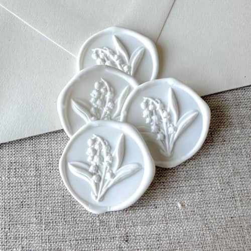 This is a white wax seals by Orchid Studio called white lily of the valley 3d wax seal stickers | set of 10 in standard