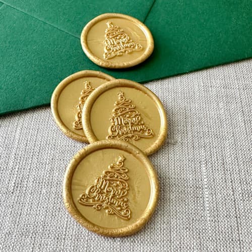 This is a gold wax seals by Orchid Studio called classic gold "merry christmas" tree calligraphy wax seal sticker | set of 10 in standard