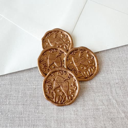 This is a gold wax seals by Orchid Studio called antique gold celebration wax seal sticker - champagne toast | set of 10 in standard
