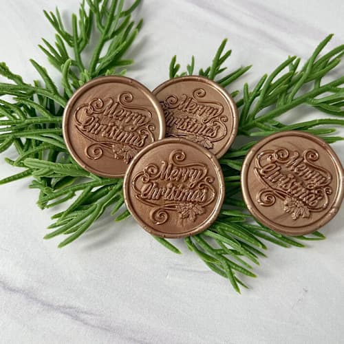 This is a gold wax seals by Honey Silks Co called merry christmas antique gold wax seal - set of 10 in standard