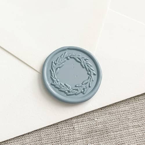 This is a blue wax seals by Orchid Studio called wreath self-adhesive wax seal in dusty blue | set of 10 in standard