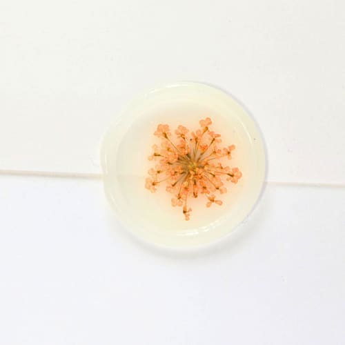 This is a multicolor wax seals by Inkspiringletters called queen anne's lace- orange dried and pressed florals on vellum- customizable shape- set of 25 wax seals in standard