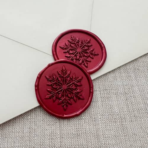 This is a red wax seals by Orchid Studio called metallic red christmas snowflake wax seal sticker | set of 10 in standard