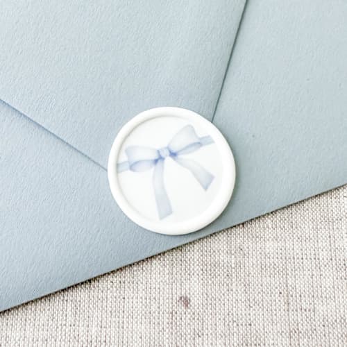 This is a blue wax seals by Orchid Studio called blue watercolor bow wax seal sticker | set of 10 in standard