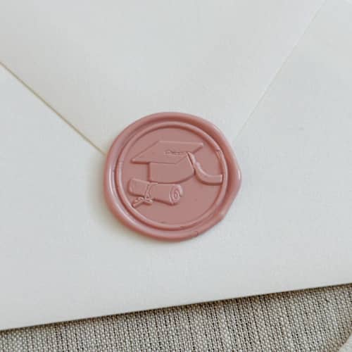 This is a pink wax seals by Orchid Studio called dusty rose graduation wax seal stickers | set of 10 in standard