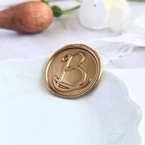 This is a multicolor wax seals by Inkspiringletters called playful cursive monogram- customizable color- set of 25 hand-crafted wax seals in standard