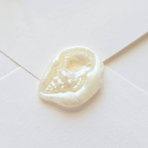 This is a multicolor wax seals by Inkspiringletters called conch - customizable color - hand-crafted wax seals- set of 25 in standard