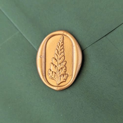 This is a multicolor wax seals by Inkspiringletters called sword fern- customizable color- set of 25 hand-crafted wax seals in standard