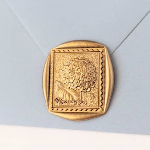This is a multicolor wax seals by Inkspiringletters called hydrangea postage- customizable color- set of 25 hand-crafted wax seals in standard