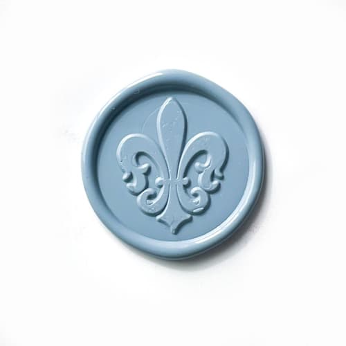 This is a blue wax seals by Abby Choi called fleur de lis wax seal in dusty blue, pack of 10 in standard