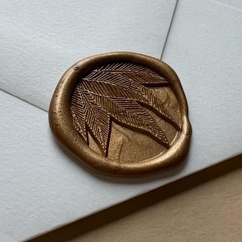 This is a gold wax seals by Eva Tadros called shady palm leaves in antique gold pack of 25 in standard
