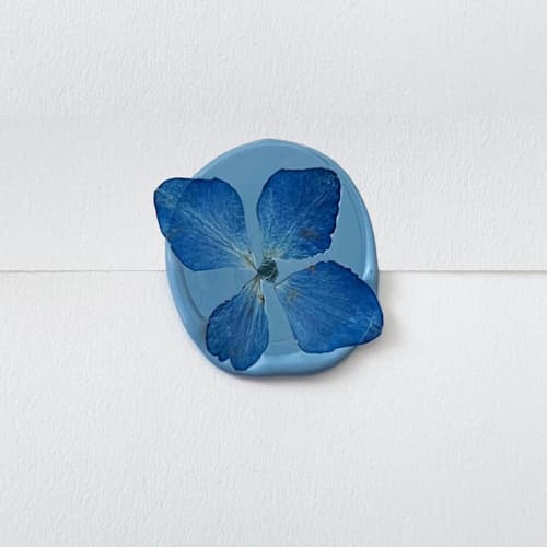 This is a blue wax seals by Caitlin Home called blue hydrangea wax seal in dusty blue | pack of 10 in standard