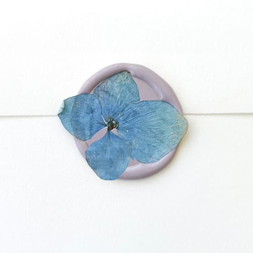 This is a blue wax seals by Caitlin Home called blue hydrangea wax seal in lilac | pack of 10 in standard