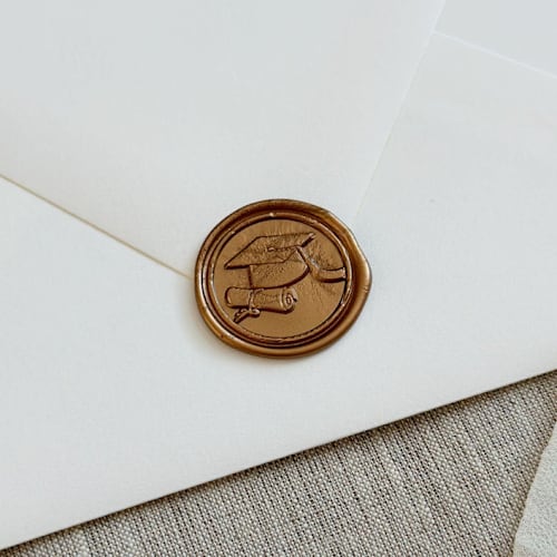 This is a bronze wax seals by Orchid Studio called antique gold graduation wax seal stickers |set of 10 in standard