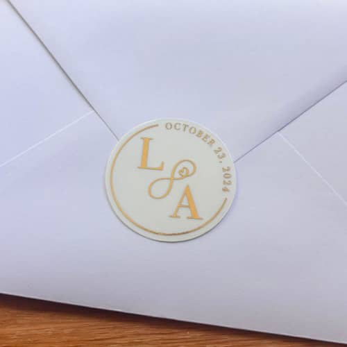 This is a gold wax seals by John O. called infinity initials foiled stamped stickers in standard