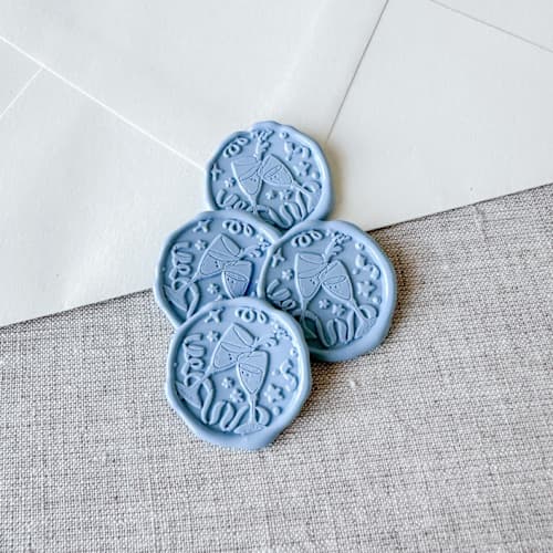 This is a blue wax seals by Orchid Studio called dusty blue celebration wax seal stickers - champagne toast | set of 10 in standard