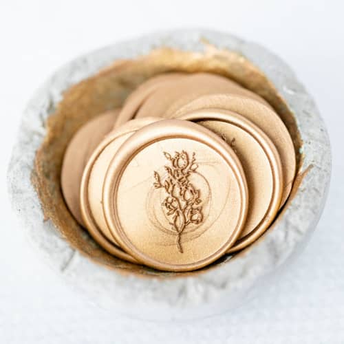 This is a gold wax seals by Lindsey Cain called forever & always (sold in sets of 10) in standard