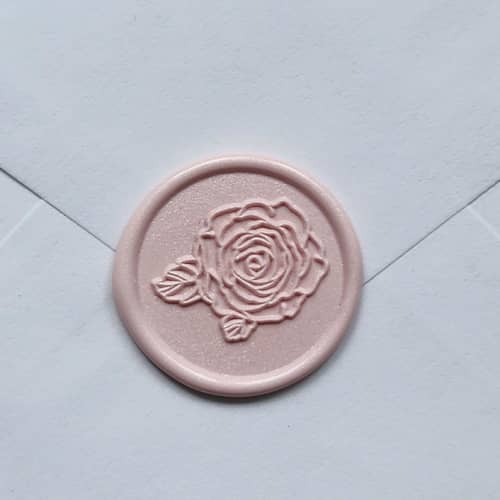 This is a white wax seals by MC silverlinings called customizable color rose head self-adhesive wax seals, set of 5 in standard